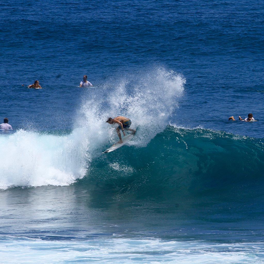 Johnny Wallbridge, owner of the Guernsey Surf School surfing at Uluwatu, Bali, Indonesia